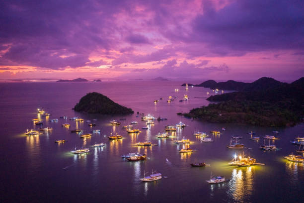 Colorful pink purple sunset twilight over the harbor of Labuan Bajo after a heavy thunderstorm - labuan bajo liveaboard